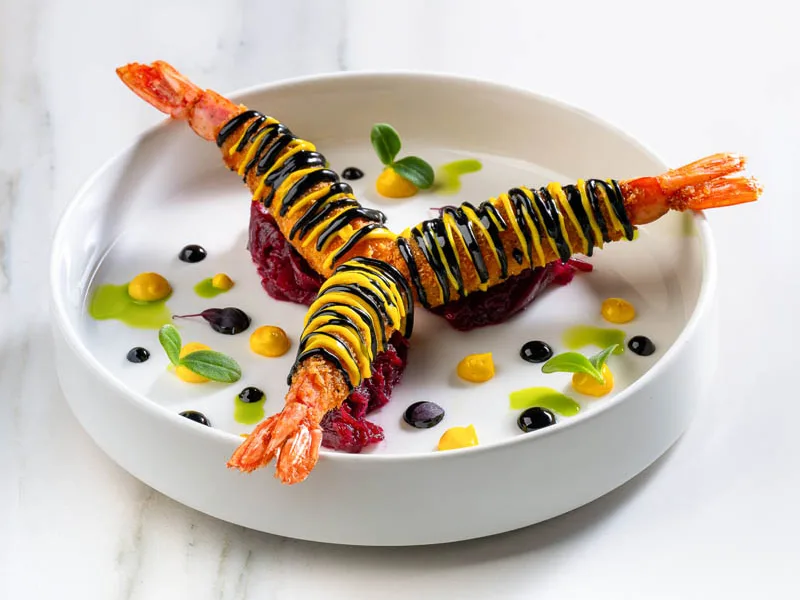 Professionally styled and plated prawn dish photographed by Looptales